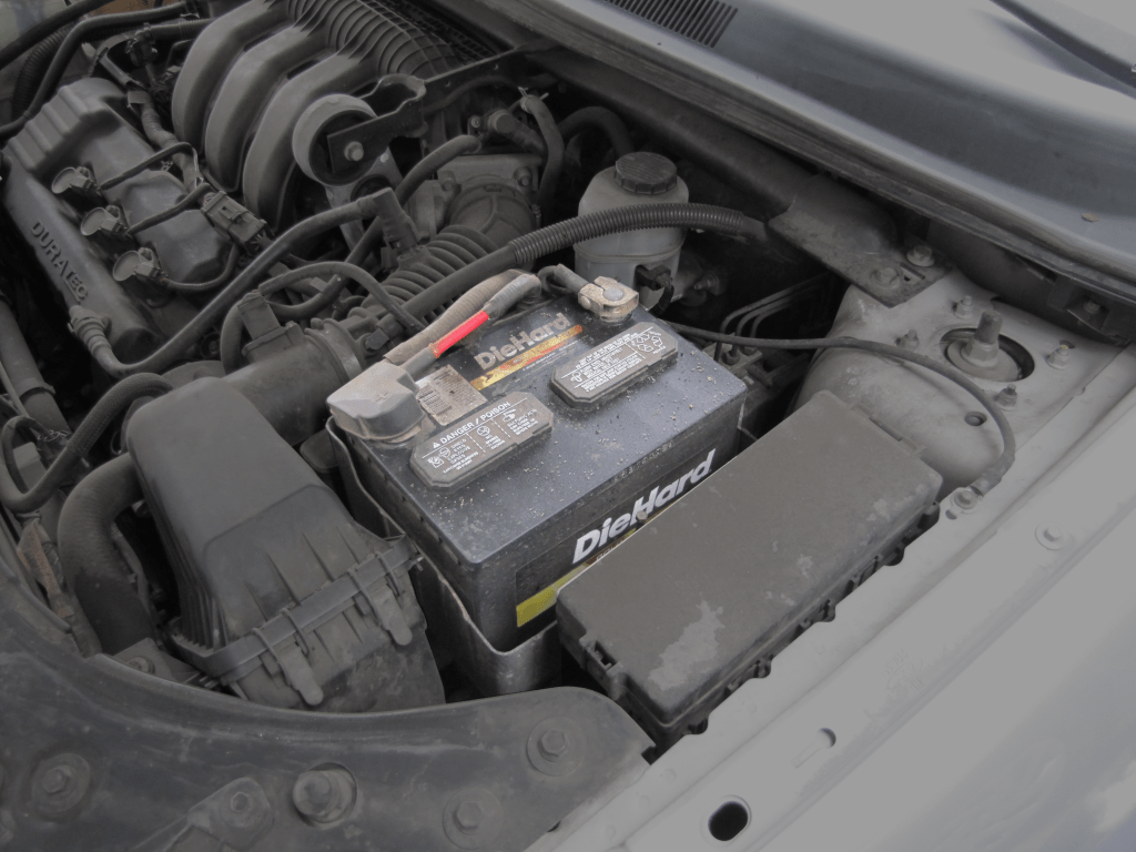 A car battery in place in a car.