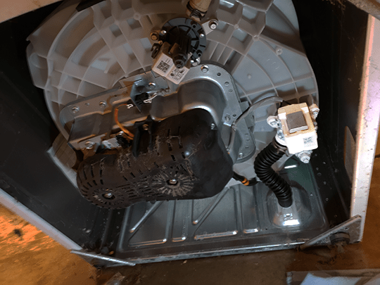 The drain pump on a recent GE washing machine is located on the bottom of the tub itself. Tilt the machine backwards to get to it.